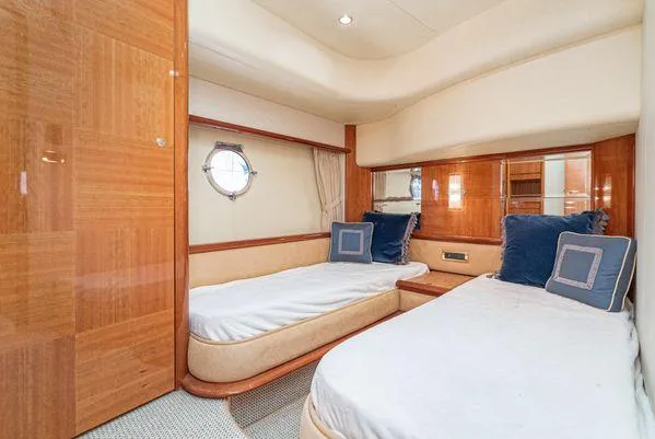 Slide: The Image of Luxurious 2007 Azimut 62 yacht cabin with twin beds and elegant wood finish. - 42