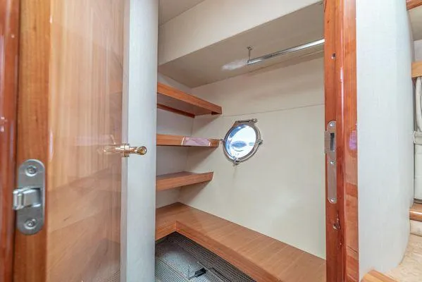 Slide: The Image of Luxurious wooden interior of 2007 Azimut 62 yacht with shelves and porthole. - 45
