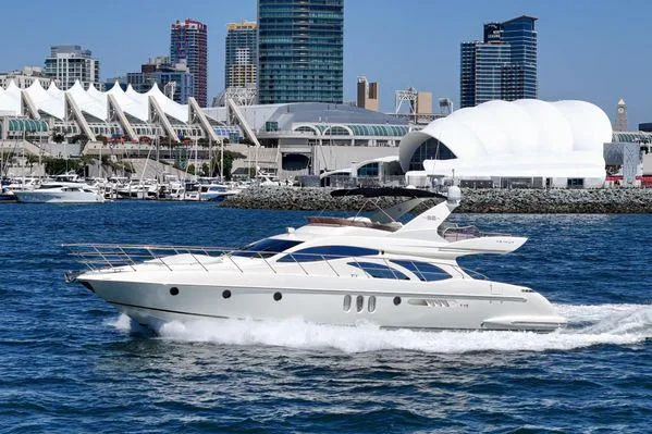 Slide: The Image of Luxury 2007 Azimut 62 yacht cruising near modern city skyline and waterfront buildings. - 8