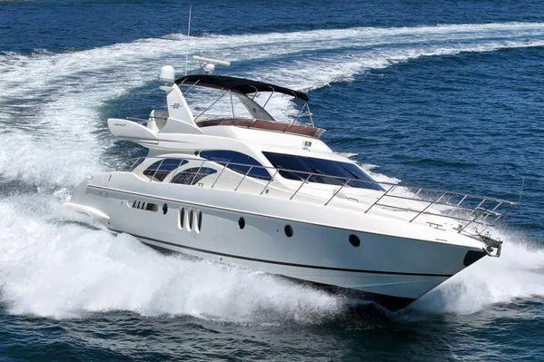 Slide: The Image of 2007 Azimut 62 yacht cruising swiftly on open blue waters. - 9