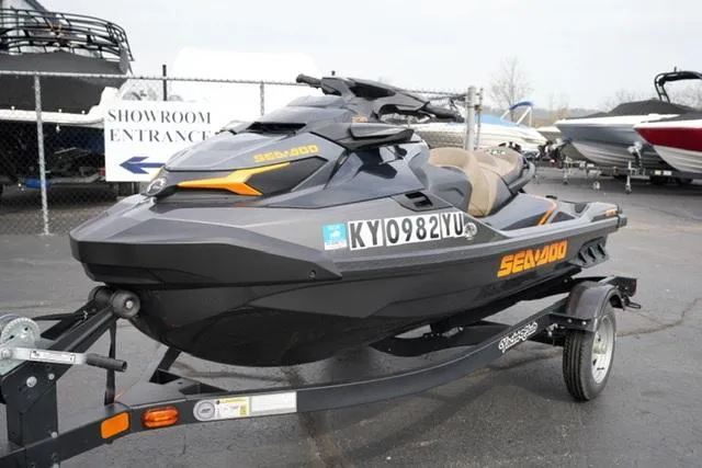 Slide: The Image of 2022 Sea-Doo GTX 230 jet ski on trailer, parked near showroom entrance. - 2