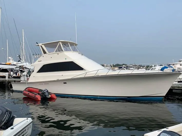The Image of 1991 Ocean Yachts 58 Super Sport docked with inflatable boat nearby. - 0