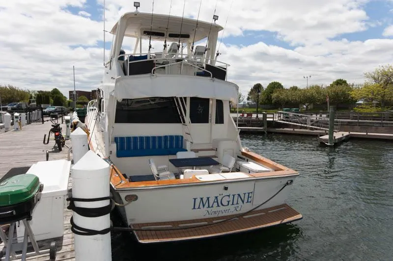 Slide: The Image of 1991 Ocean Yachts 58 Super Sport docked at marina under cloudy sky. - 2
