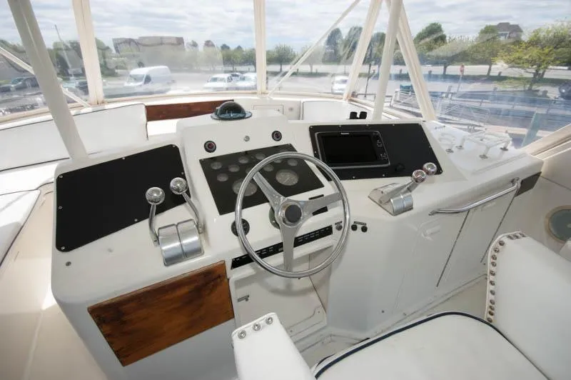 Slide: The Image of 1991 Ocean Yachts 58 Super Sport helm with steering wheel and control panels. - 20