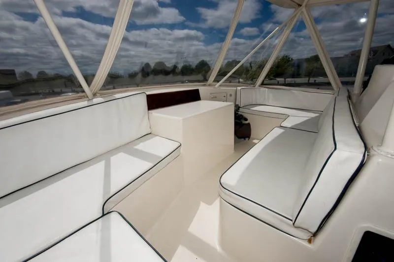 Slide: The Image of 1991 Ocean Yachts 58 Super Sport interior with white seating and panoramic windows. - 23