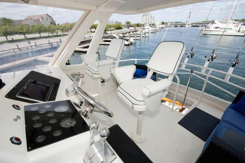 Slide: The Image of Cockpit of 1991 Ocean Yachts 58 Super Sport with white seating and control panel. - 24