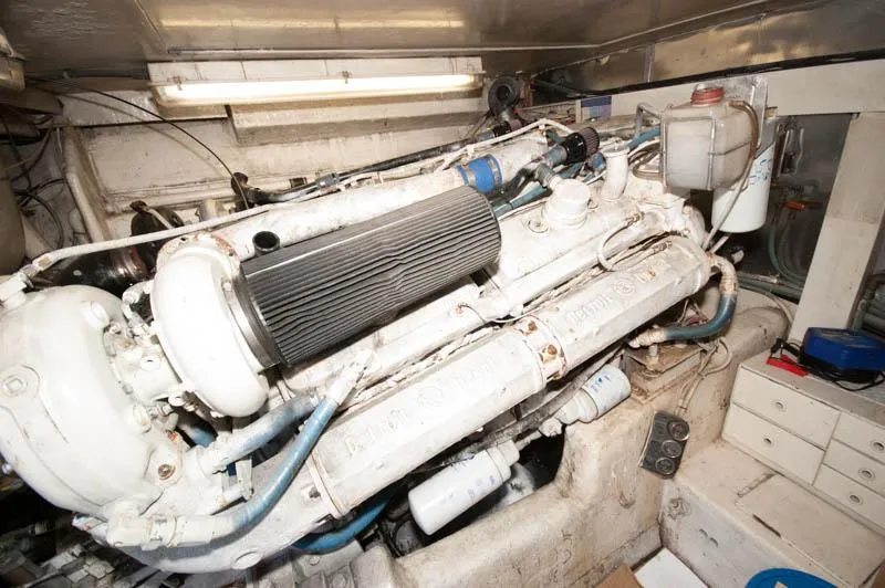Slide: The Image of Engine room of a 1991 Ocean Yachts 58 Super Sport, showcasing a powerful marine engine. - 30