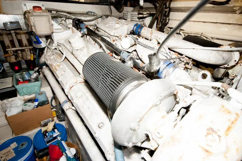 Slide: The Image of Engine room of 1991 Ocean Yachts 58 Super Sport, showcasing mechanical components and storage. - 34