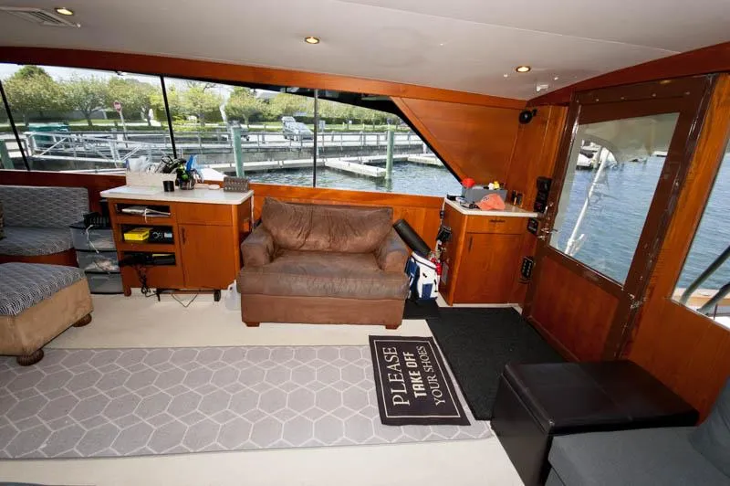 Slide: The Image of Interior of 1991 Ocean Yachts 58 Super Sport with cozy seating and waterfront view. - 7