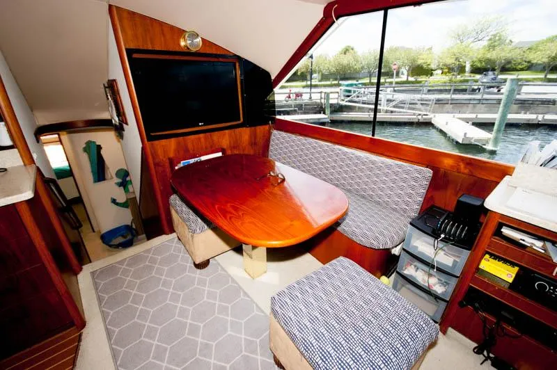 Slide: The Image of Interior of 1991 Ocean Yachts 58 Super Sport with dining area and marina view. - 8