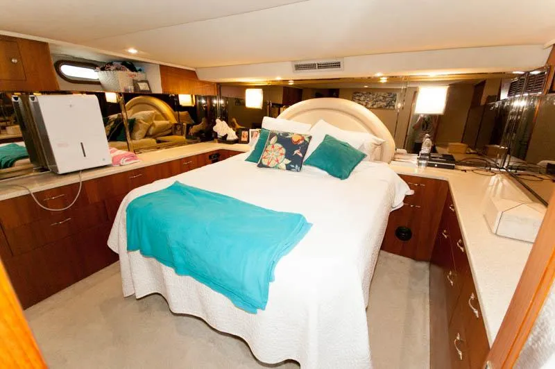 Slide: The Image of Luxurious bedroom interior of 1991 Ocean Yachts 58 Super Sport with elegant bedding. - 14
