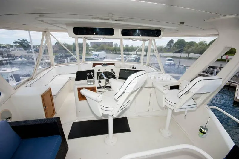 Slide: The Image of Cockpit of 1991 Ocean Yachts 58 Super Sport with dual captain chairs and control panel. - 21