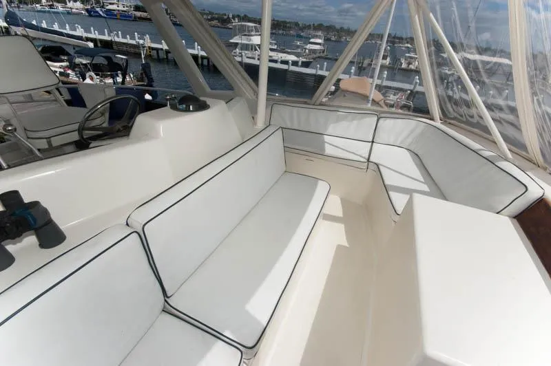 Slide: The Image of Luxurious seating area on a 1991 Ocean Yachts 58 Super Sport, docked at a marina. - 22