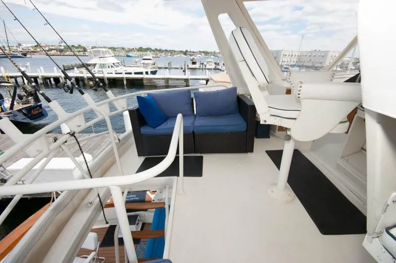 Slide: The Image of 1991 Ocean Yachts 58 Super Sport deck with seating and marina view. - 25