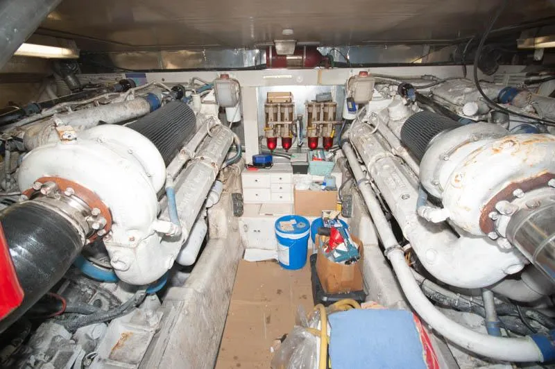 Slide: The Image of Engine room of a 1991 Ocean Yachts 58 Super Sport, showcasing dual engines and equipment. - 28