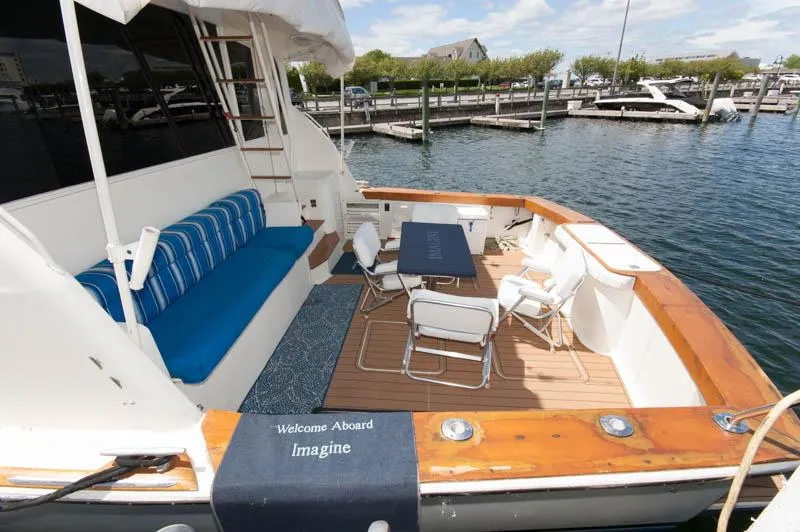 Slide: The Image of 1991 Ocean Yachts 58 Super Sport deck with seating and table, docked at marina. - 4