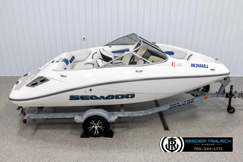 Slide: The Image of 2007 Sea-Doo 180 Challenger boat on trailer, white exterior, displayed indoors. - 1