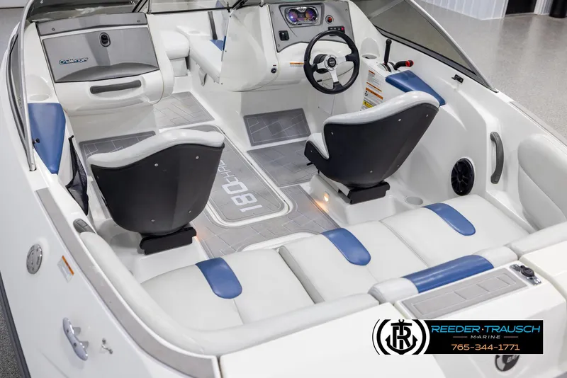 Slide: The Image of 2007 Sea-Doo 180 Challenger interior with white and blue seating, steering wheel, and dashboard. - 11