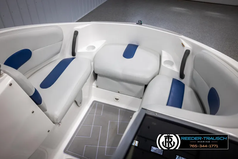Slide: The Image of 2007 Sea-Doo 180 Challenger interior with white and blue seating, featuring cup holders and storage. - 19