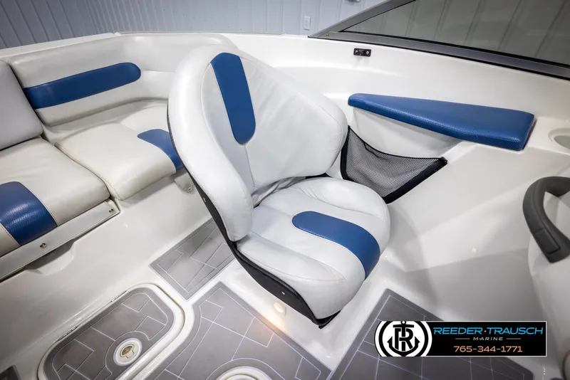 Slide: The Image of 2007 Sea-Doo 180 Challenger interior with white and blue seating, featuring a swivel chair. - 21