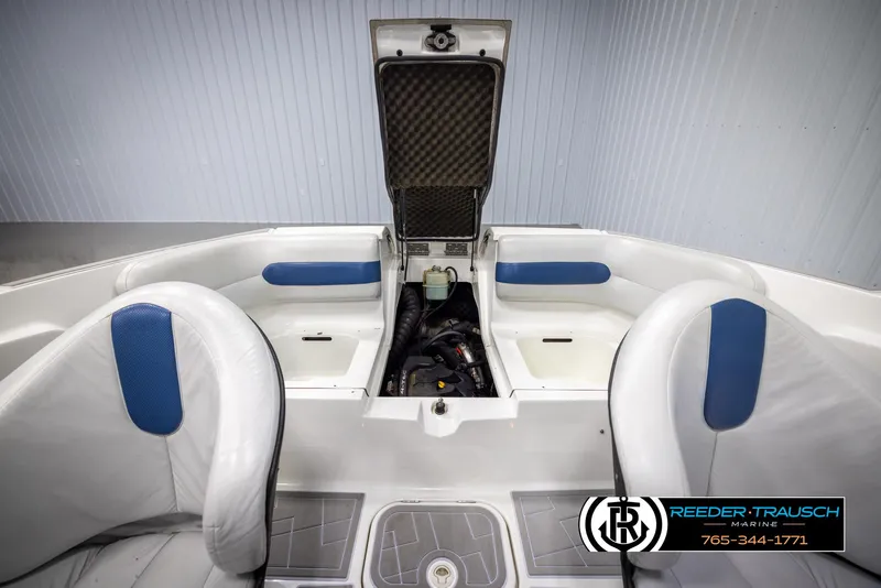 Slide: The Image of 2007 Sea-Doo 180 Challenger interior with open engine compartment, white and blue seating. - 28