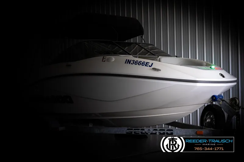Slide: The Image of 2007 Sea-Doo 180 Challenger boat on trailer in dimly lit storage. - 4