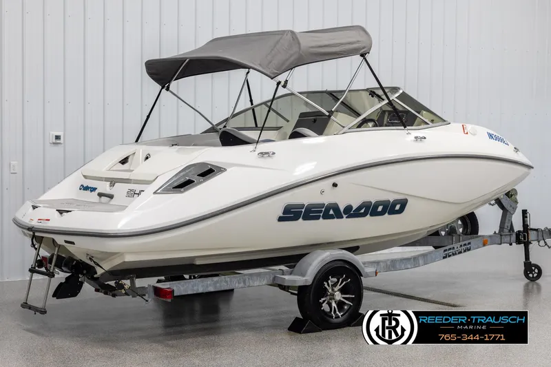 Slide: The Image of 2007 Sea-Doo 180 Challenger boat on trailer with canopy in indoor setting. - 6
