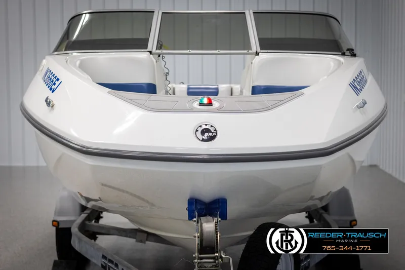 Slide: The Image of 2007 Sea-Doo 180 Challenger boat on trailer, front view in indoor setting. - 8