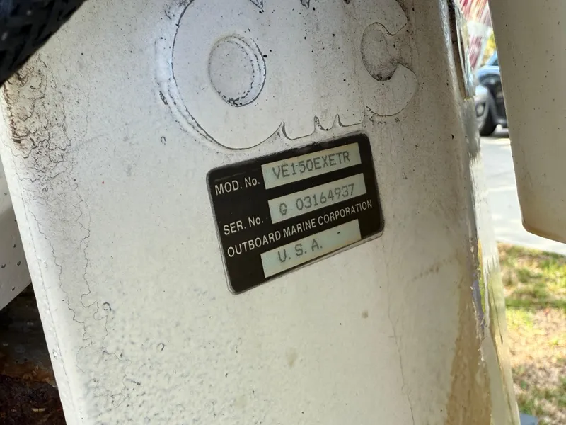 Slide: The Image of 1996 Boston Whaler Outrage 17, Outboard Marine Corporation label, model VET50EXETR, serial G03164937. - 11