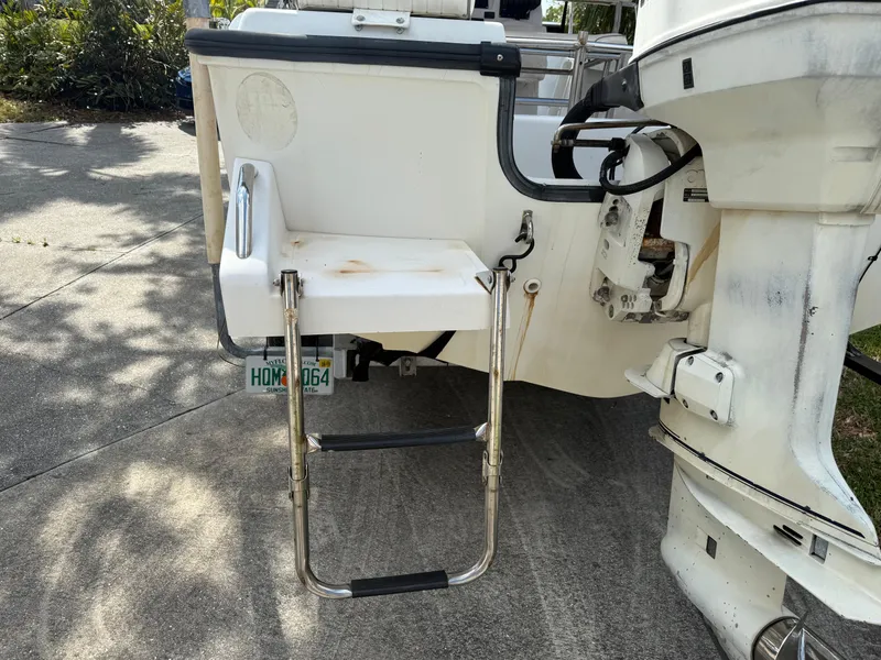 Slide: The Image of 1996 Boston Whaler Outrage 17 boat with swim ladder and outboard motor. - 12
