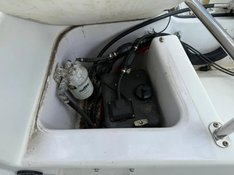 Slide: The Image of 1996 Boston Whaler Outrage 17 engine compartment with visible wiring and components. - 18
