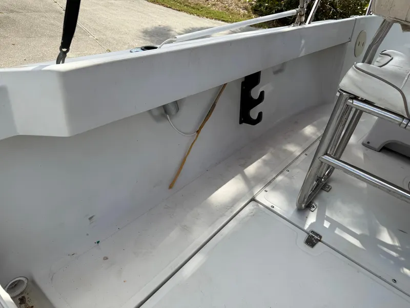 Slide: The Image of 1996 Boston Whaler Outrage 17 interior, featuring seating and storage area. - 26