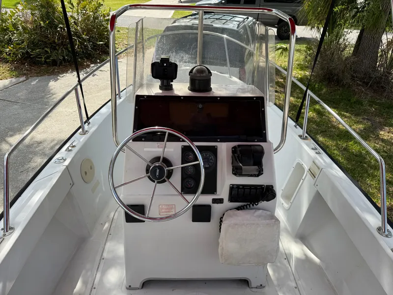 Slide: The Image of 1996 Boston Whaler Outrage 17 boat console with steering wheel and navigation equipment. - 29