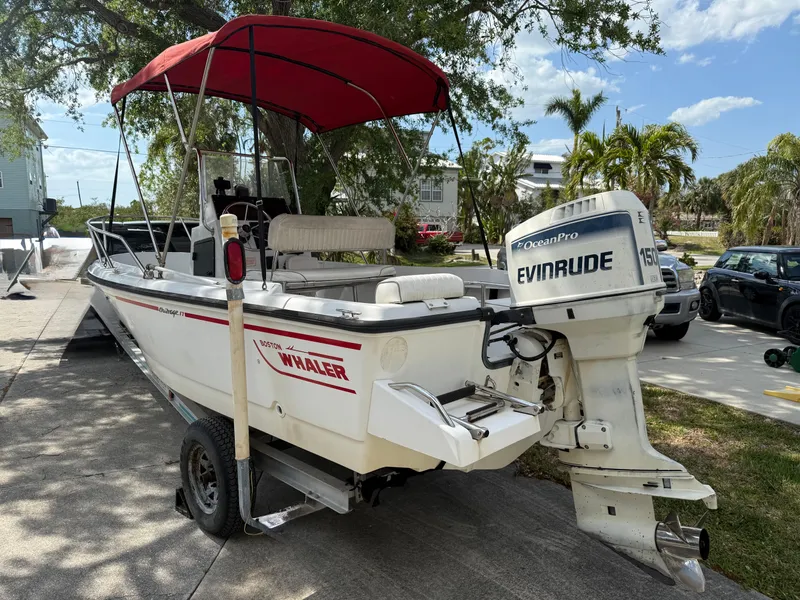 Slide: The Image of 1996 Boston Whaler Outrage 17 boat with Evinrude motor and red canopy on trailer. - 3