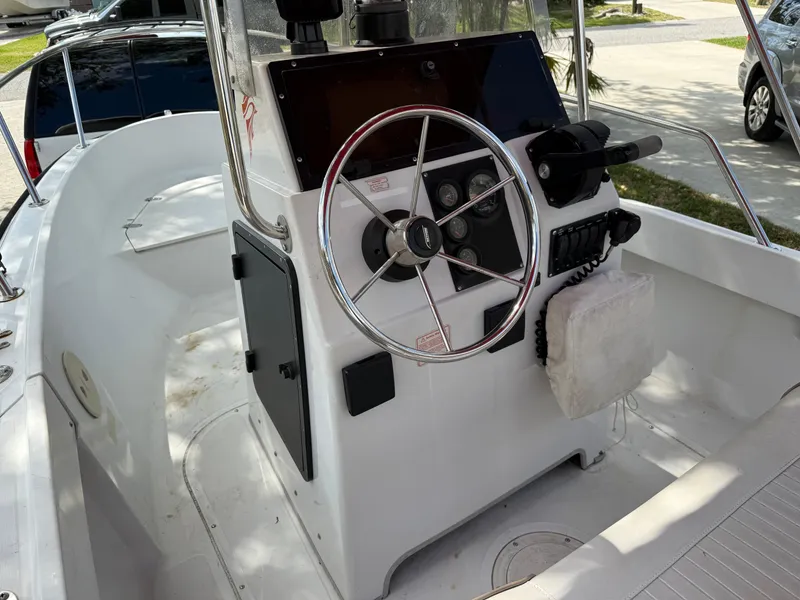 Slide: The Image of 1996 Boston Whaler Outrage 17 boat console with steering wheel and controls. - 30