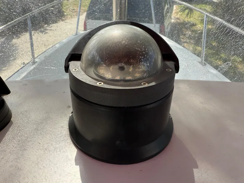 Slide: The Image of Compass on 1996 Boston Whaler Outrage 17 boat deck, under sunlight. - 33