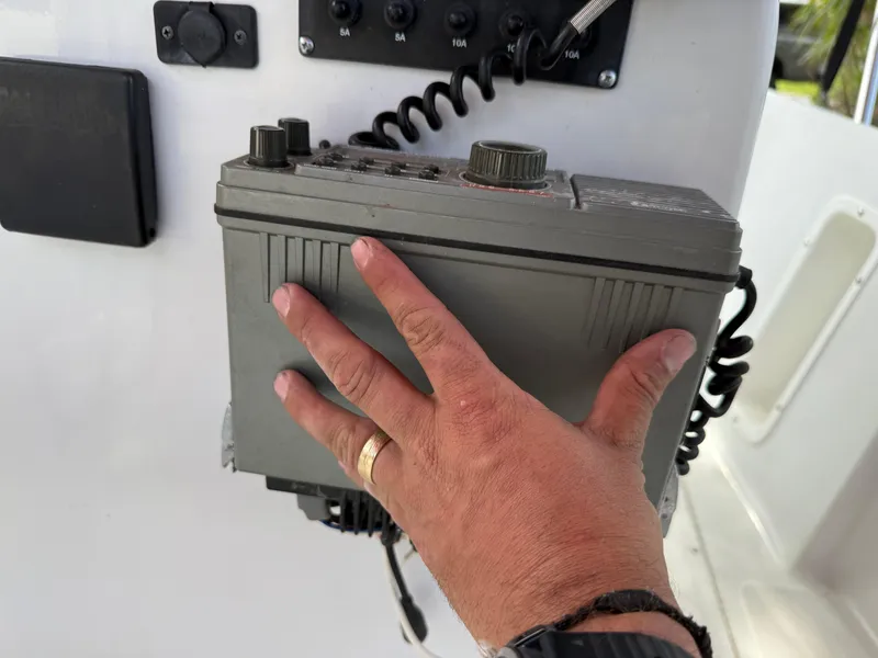 Slide: The Image of Hand adjusting radio on 1996 Boston Whaler Outrage 17 boat console. - 35