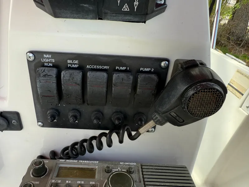 Slide: The Image of Control panel with switches and radio on a 1996 Boston Whaler Outrage 17 boat. - 36