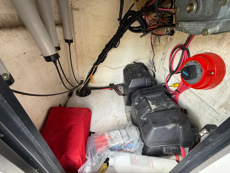 Slide: The Image of Interior of a 1996 Boston Whaler Outrage 17 boat showing wiring and equipment storage. - 39