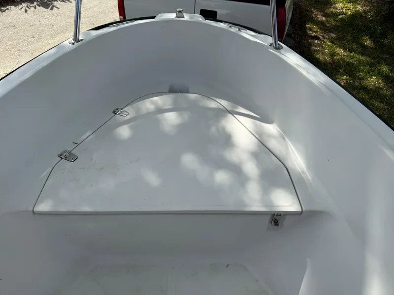 Slide: The Image of 1996 Boston Whaler Outrage 17 boat interior, featuring a clean, white storage compartment. - 43