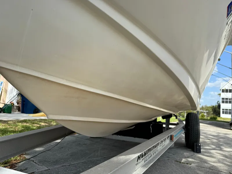 Slide: The Image of 1996 Boston Whaler Outrage 17 boat on trailer, showing hull design and structure. - 6