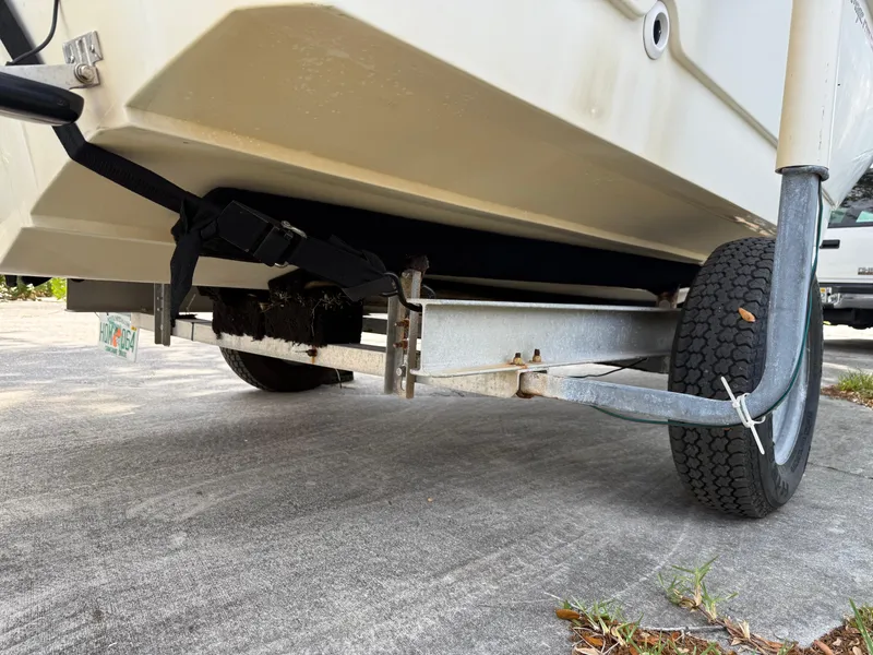 Slide: The Image of 1996 Boston Whaler Outrage 17 on trailer, showing hull and wheel detail. - 7