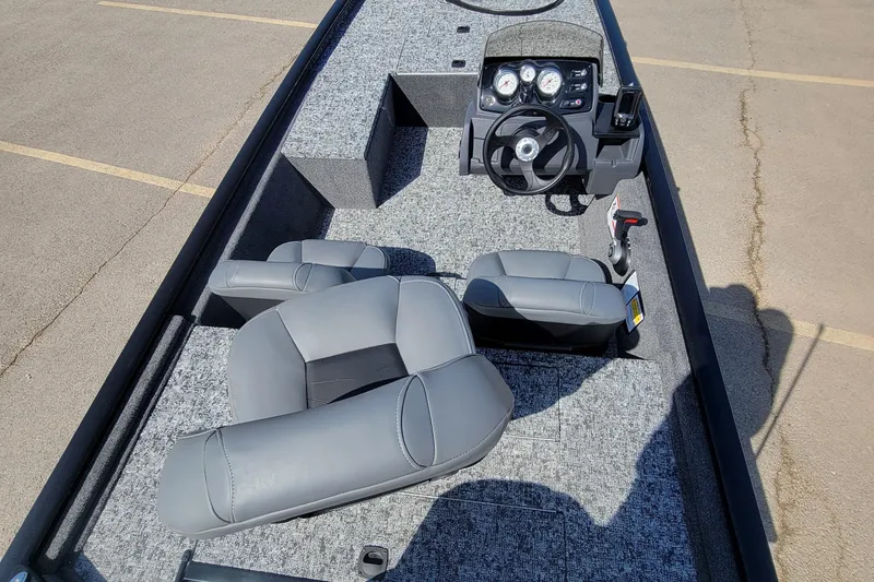 Slide: The Image of 2025 Tracker Pro 170 boat interior with gray seating and steering console. - 2