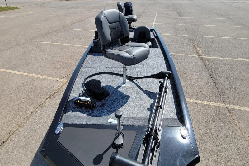 Slide: The Image of 2025 Tracker Pro 170 boat with seating and equipment in a parking lot. - 3