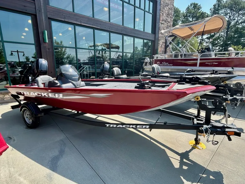Slide: The Image of 2025 Tracker Pro 170 boat in red, displayed outdoors on a trailer. - 2