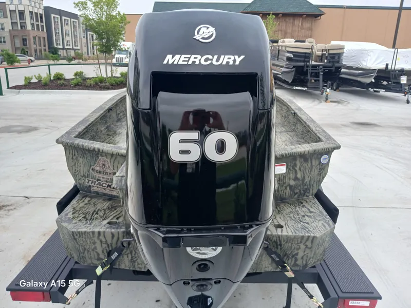 Slide: The Image of 2025 Tracker Grizzly 1650 T Prairie Wings Edition with Mercury 60 engine, camo design. - 6