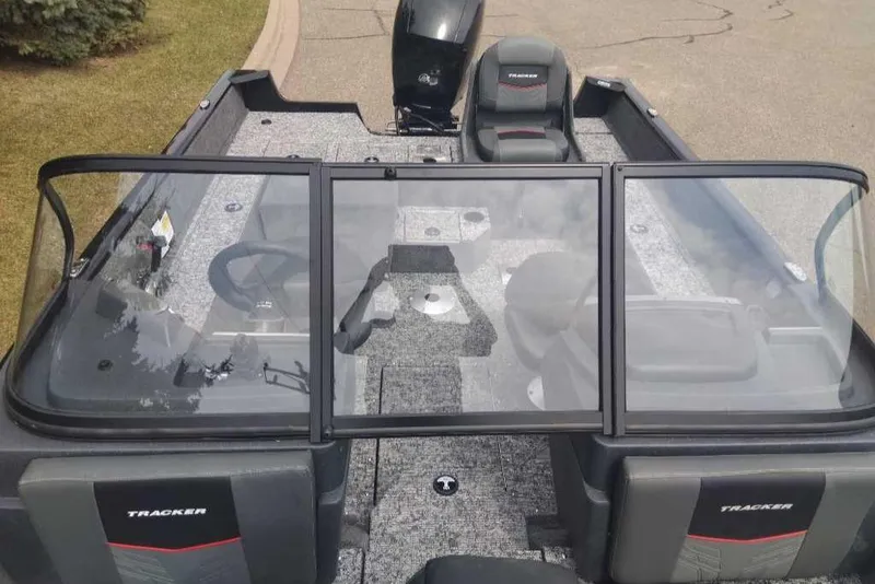 Slide: The Image of 2025 Tracker Pro Guide V-175 Combo boat interior with seating and steering wheel. - 2