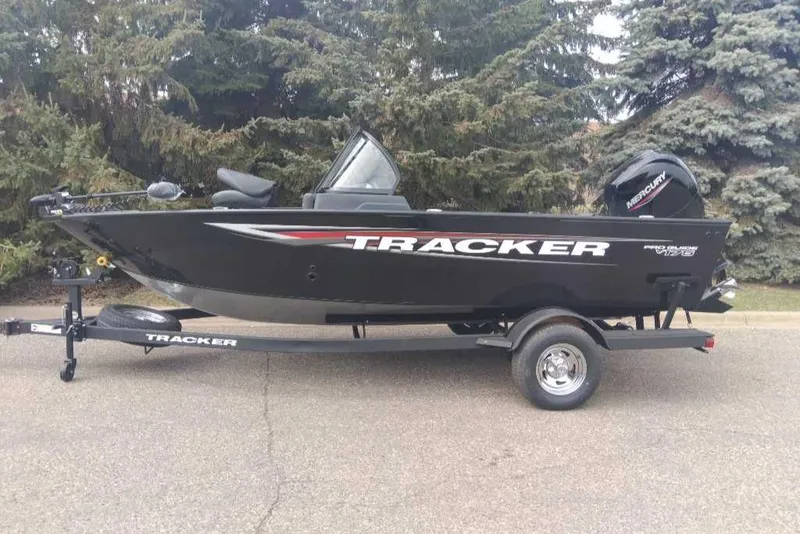 Slide: The Image of 2025 Tracker Pro Guide V-175 Combo boat on trailer, parked outdoors. - 7