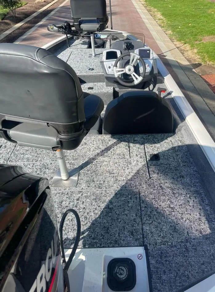 Slide: The Image of 2025 Tracker Pro Team 175 boat interior with steering wheel and seating. - 4