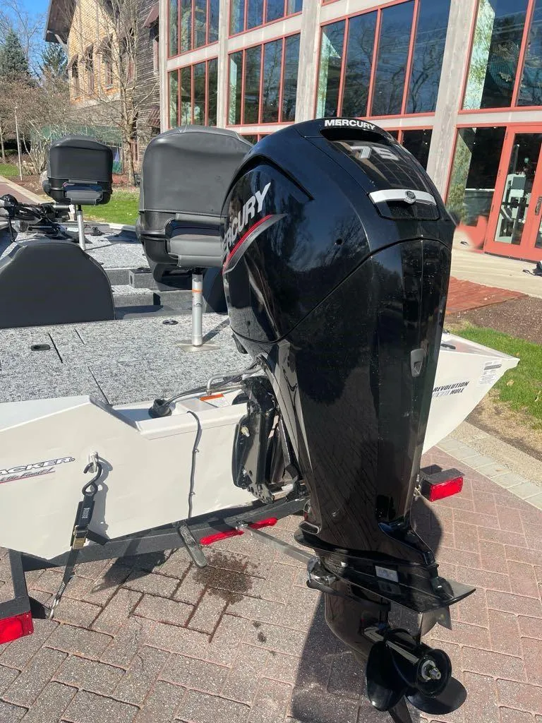 Slide: The Image of 2025 Tracker Pro Team 175 boat with Mercury outboard motor, parked outdoors. - 7